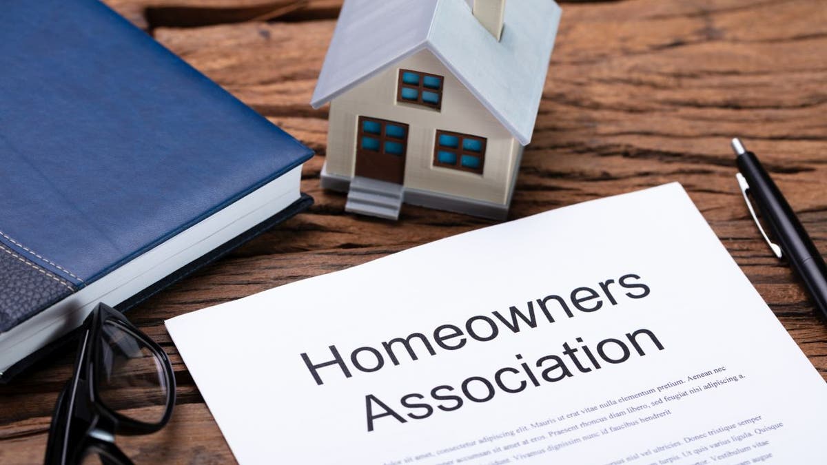 House model near homeowner association rules and regulations booklet.