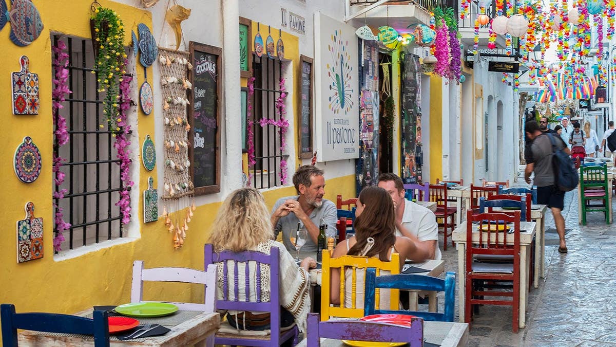 People sitting at a table in a small cozy restaurant in Ibiza Town