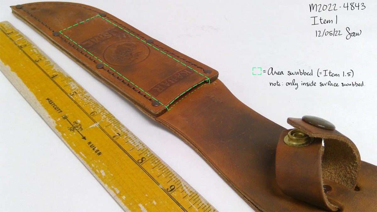 KA-BAR knife sheath displayed on a surface as evidence in a murder case