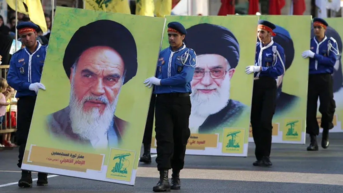 Hezbollah al-Mahdi scouts parading with portraits of Ayatollah Khomeini and Ayatollah Khamenei in Nabatiyeh Lebanon