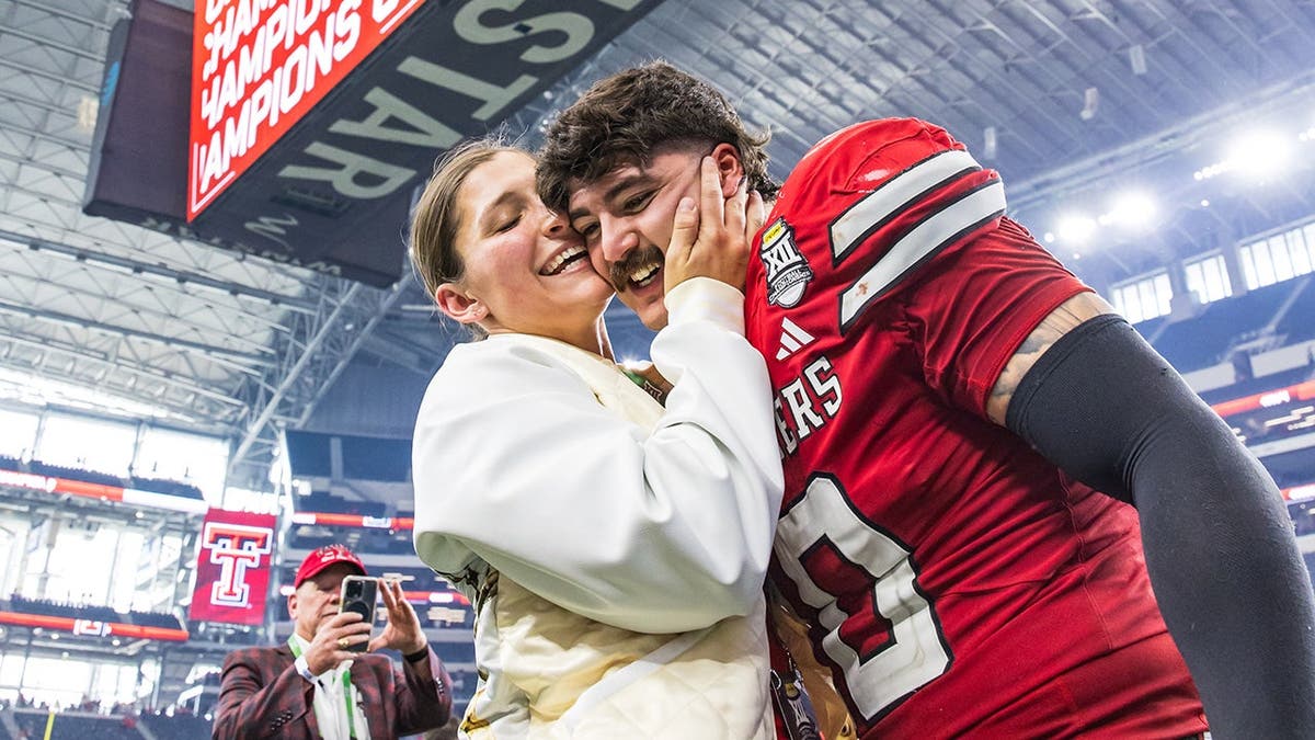 Jacob Rodriguez and his wife Emma Rodriguez celebrating at AT&T Stadium