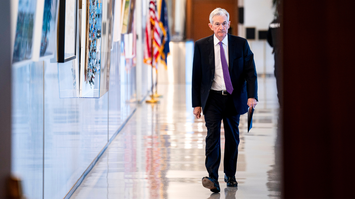 Jerome Powell walking outside Federal Reserve headquarters in Washington, D.C.