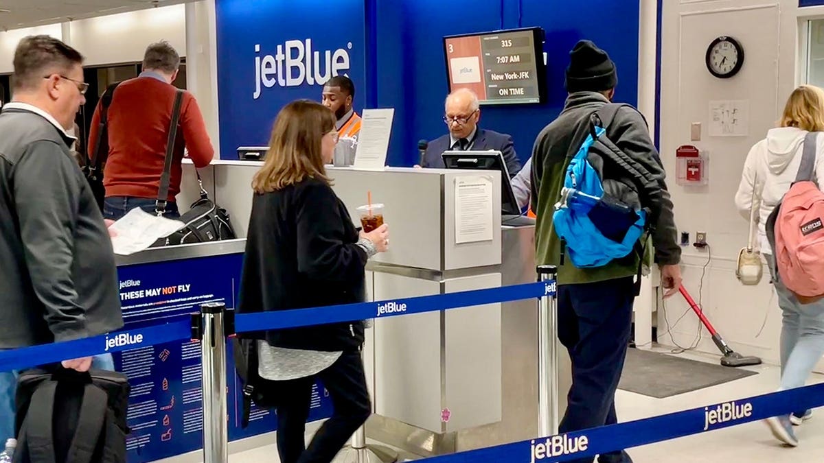 Passengers boarding a JetBlue Airlines flight at JFK International Airport in New York