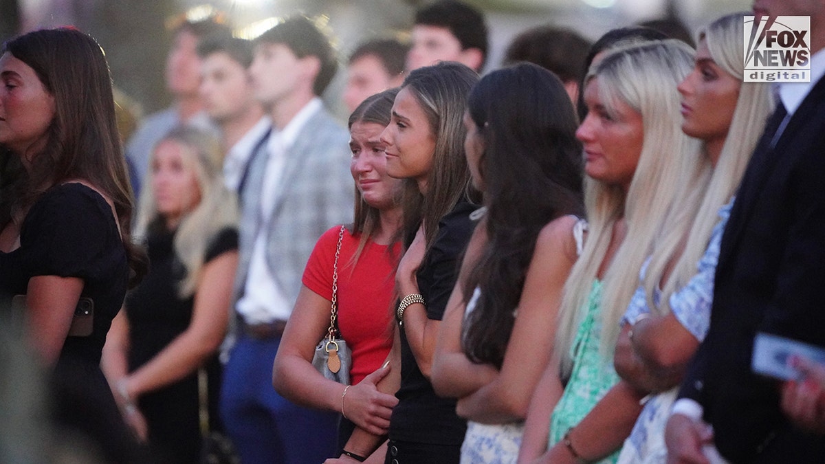 Mourners at a memorial vigil for Jimmy Gracey standing together