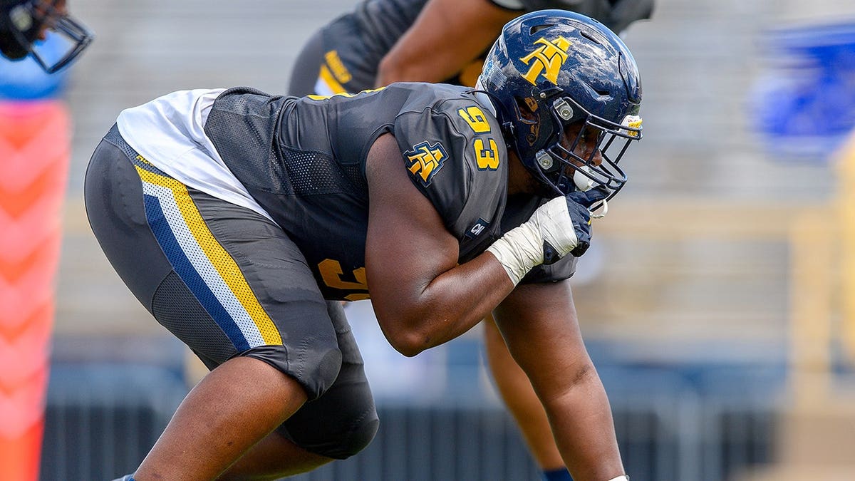 Kelvin Broadhurst Jr in a three-point stance on football field