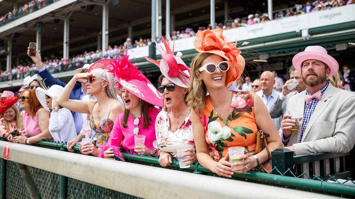 Attendees wearing colorful hats at Kentucky Derby preview day at Churchill Downs in Louisville