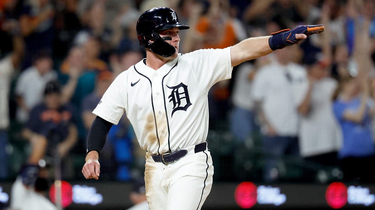 Detroit Tigers shortstop Kevin McGonigle diving to home plate at Comerica Park