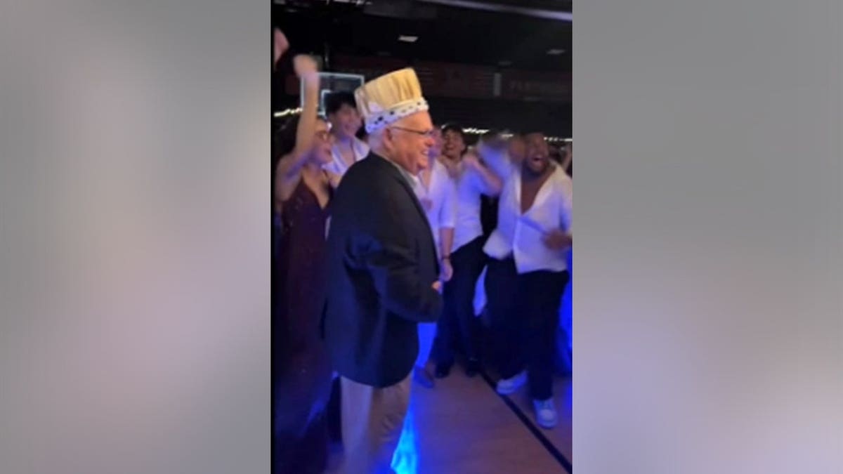 A high school principal wearing a crown at a party