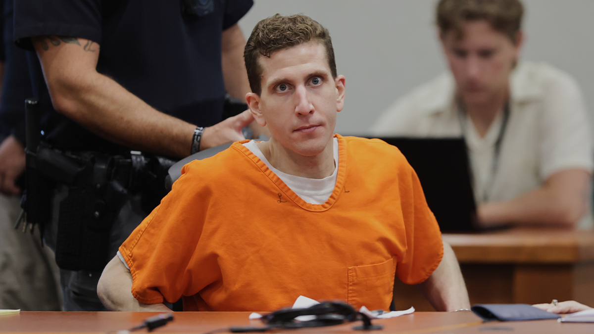 Bryan Kohberger adjusting his seat wearing an orange jail jumpsuit in a courtroom