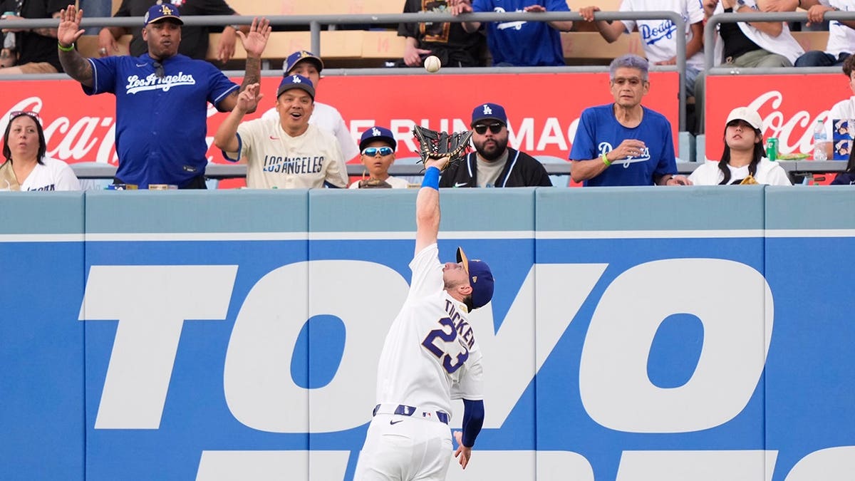 Los Angeles Dodgers right fielder Kyle Tucker catching a baseball during a game.