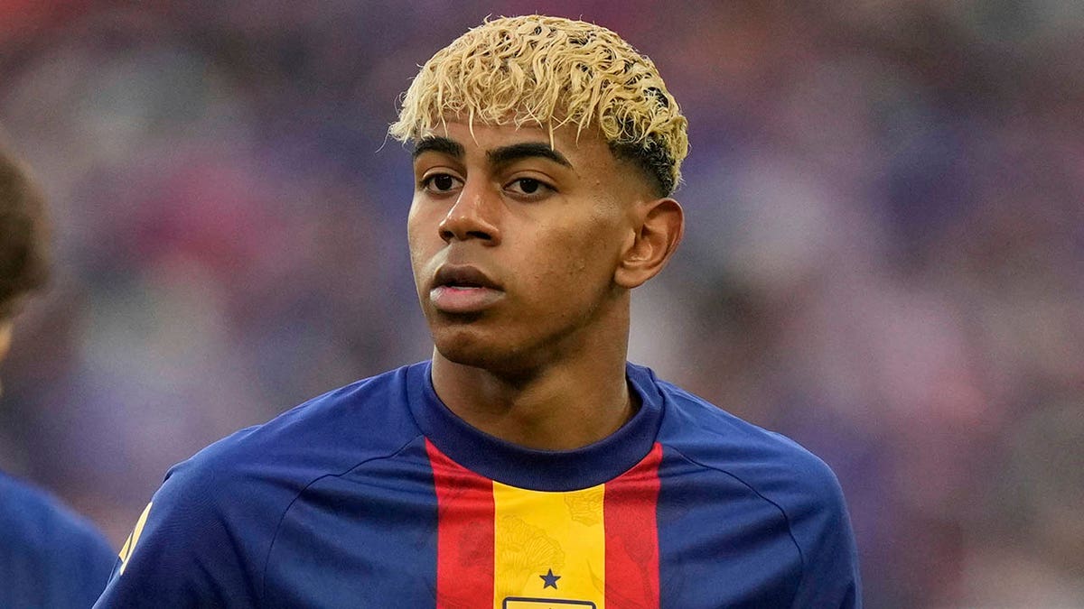 Spain's Lamine Yamal warming up on the soccer field in Stuttgart