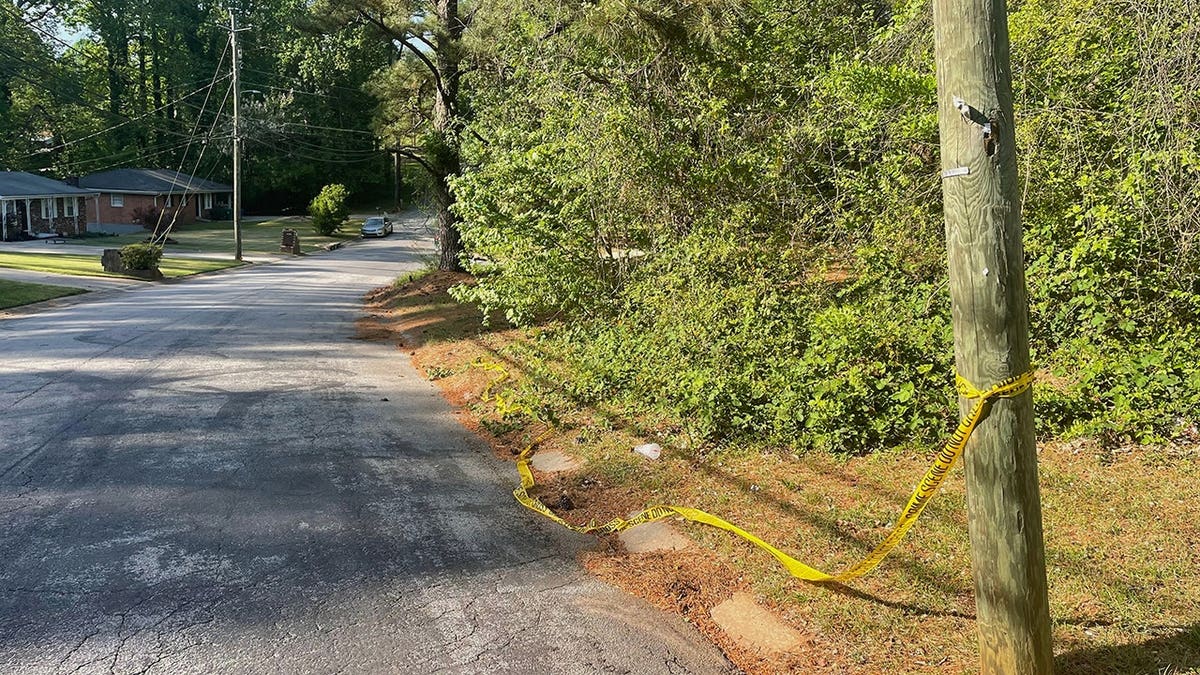 Crime scene tape tied around a pole near the site where Lauren Bullis was killed in Panthersville, Ga.