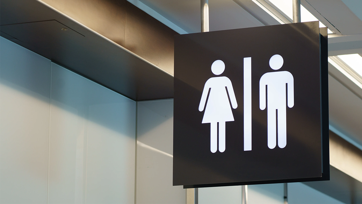Bathroom entrance sign indicating men and women restrooms.
