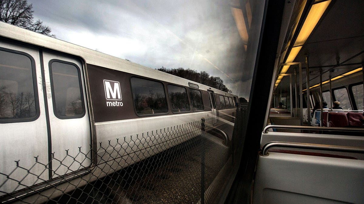 Metro silver line train passing another Metro train on lower rail in Washington, DC