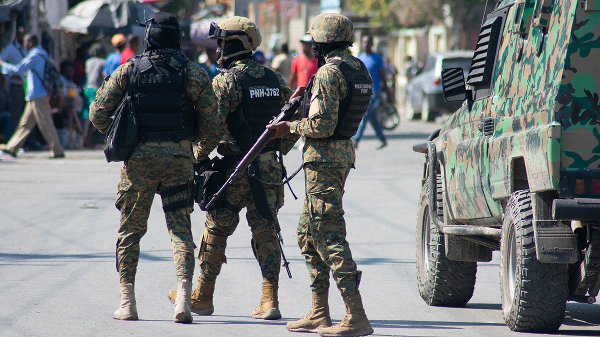 Haitian police officers deploying in Port-au-Prince street