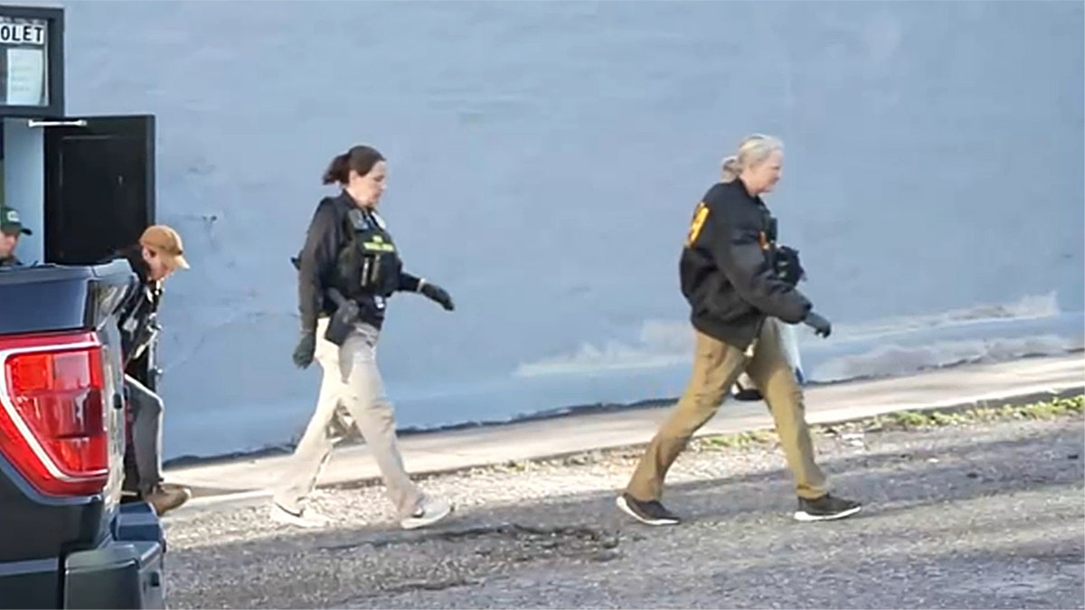 Law enforcement agents walking out of a building