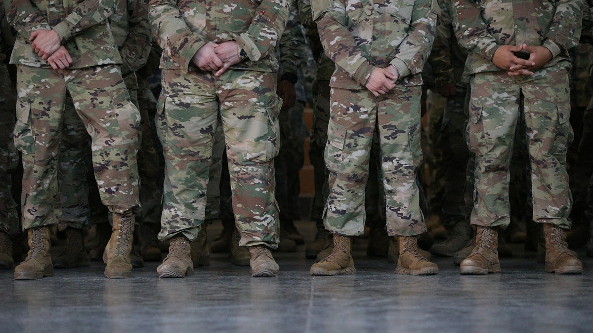 Members of the Texas National Guard wait for Governor Greg Abbott to speak about security on the Mexico-U.S. border at Sergeant Tomas Garces Texas Army National Guard Armory in Weslaco, Texas, U.S., April 12, 2018. REUTERS/Loren Elliott - RC1FFD3AC1E0