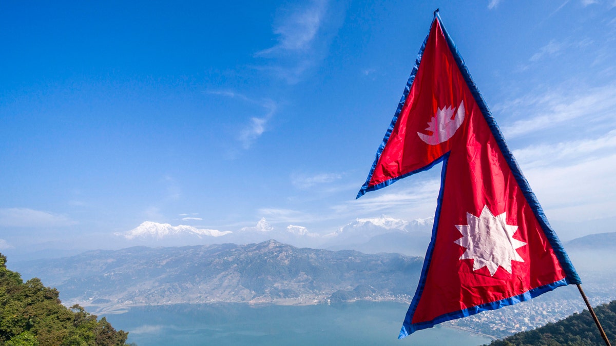 Nepali flag flying over Phewa Lake in Thumki Nepal