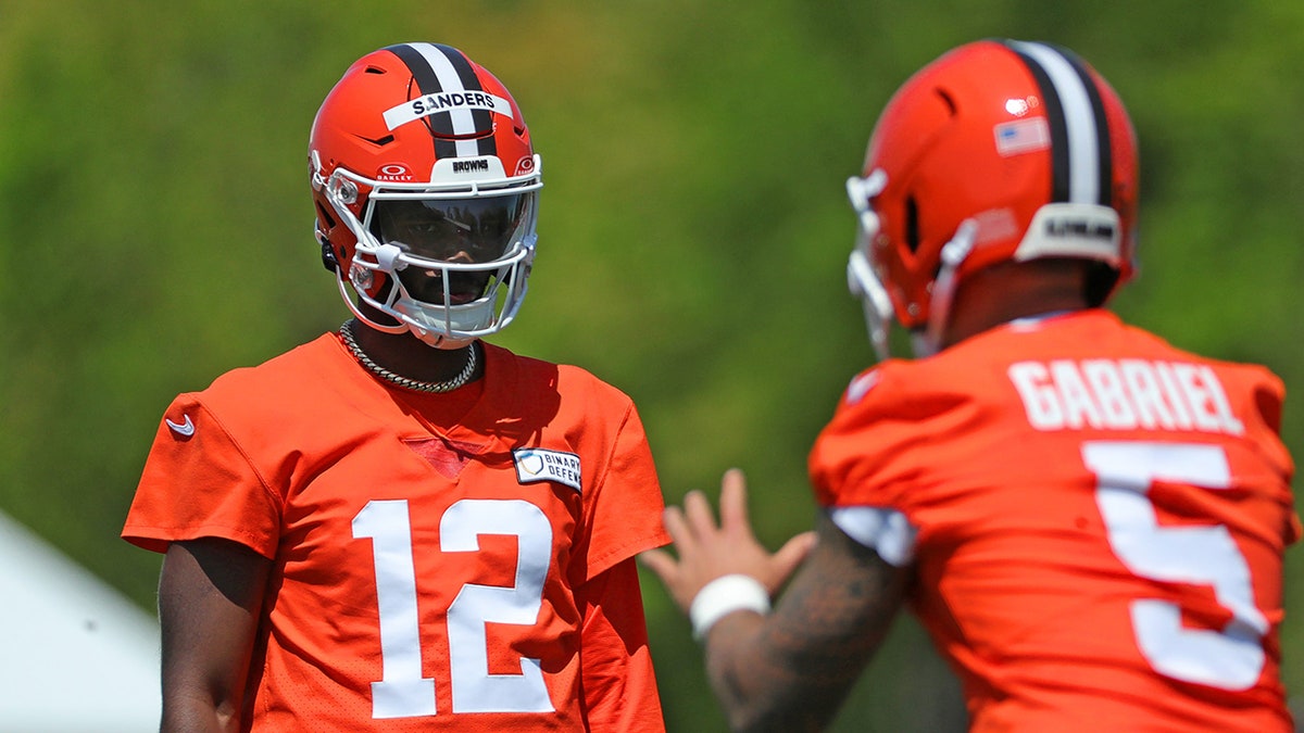 Cleveland Browns quarterbacks Shedeur Sanders and Dillon Gabriel on field during rookie minicamp
