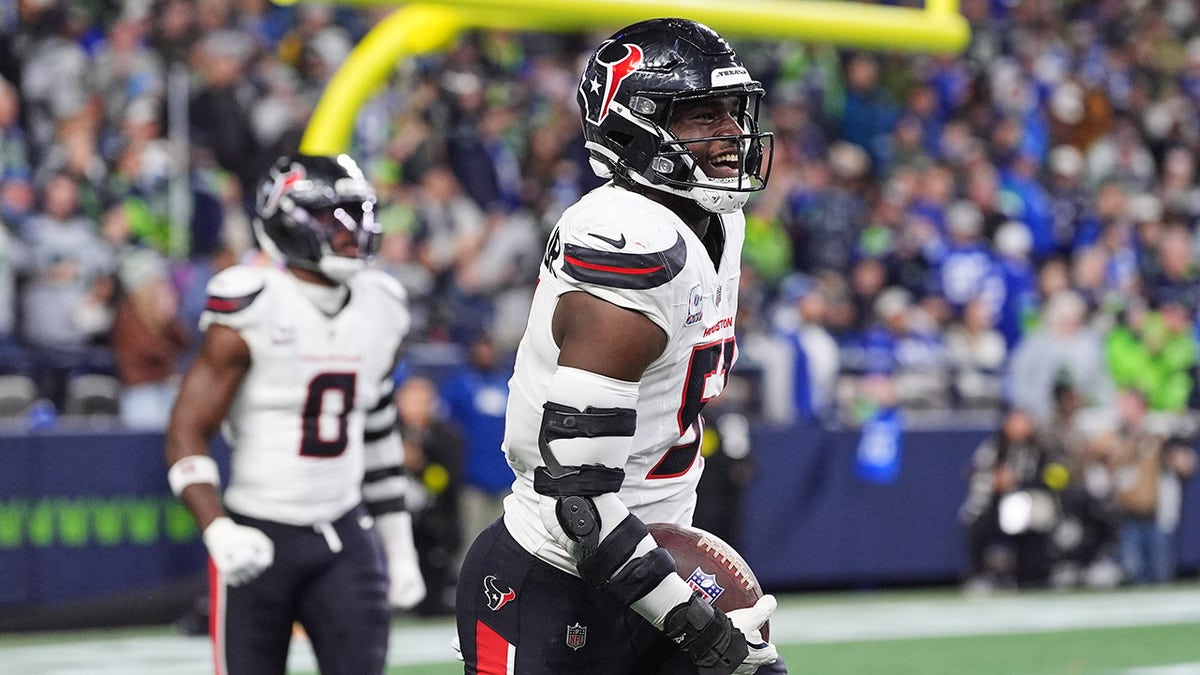 Houston Texans defensive end Will Anderson Jr. celebrating a touchdown on the field.