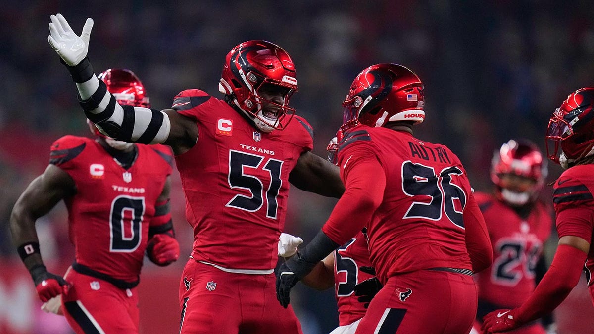 Will Anderson Jr. and Denico Autry celebrating a sack during an NFL game in Houston