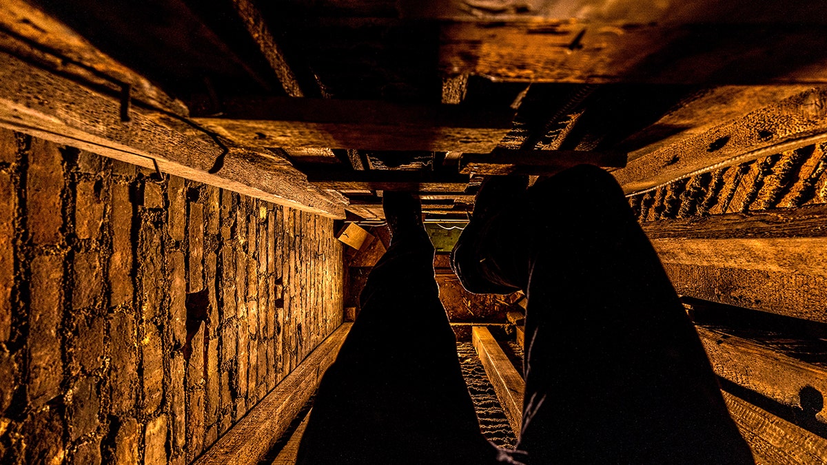 Man walking down passageway
