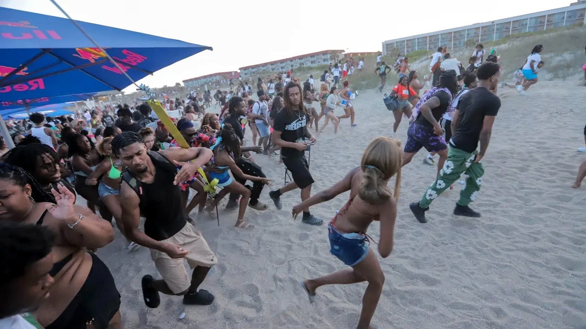 Festival goers run from the stage after someone yelled that a gun was seen on Saturday, April 19, 2025 during Orange Crush on Tybee Island.