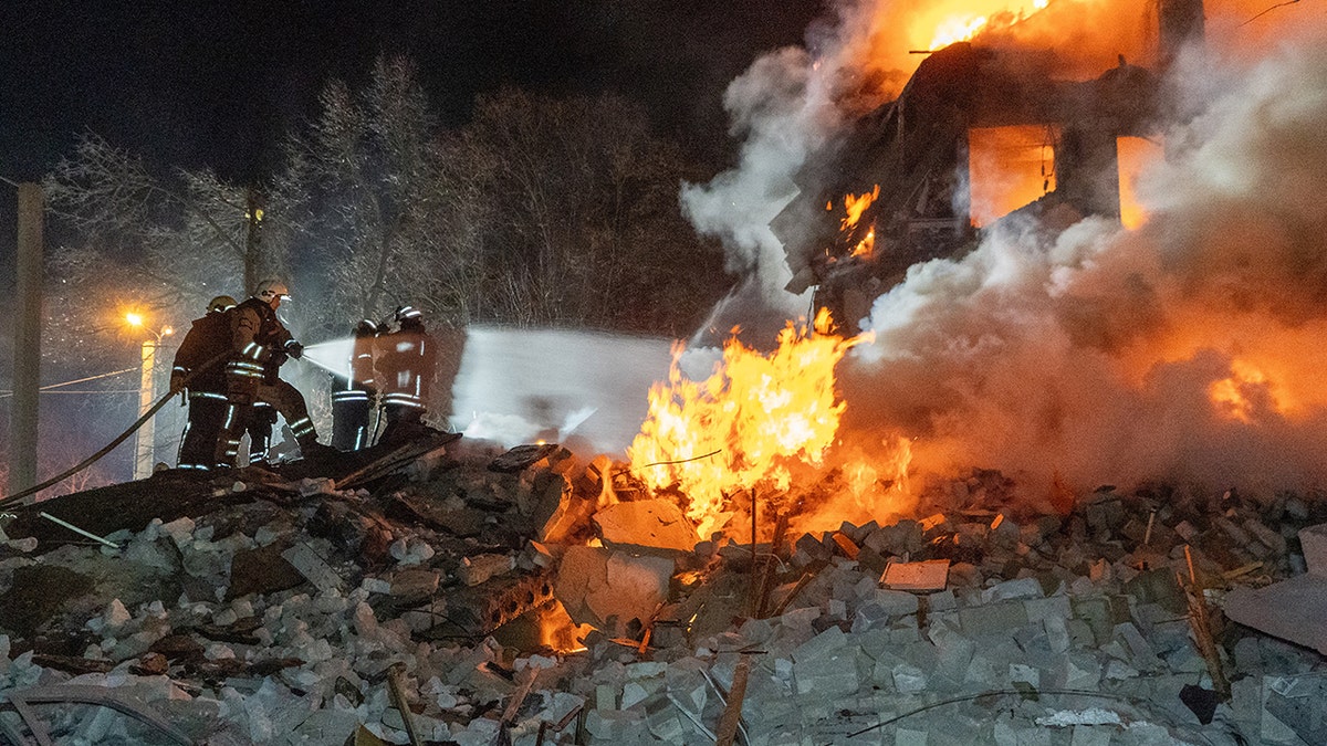 Firefighters extinguishing fire in a multi-story apartment building in Kharkiv