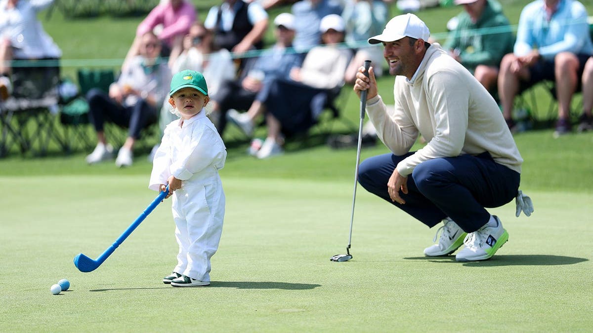 Scottie Scheffler smiling with son Bennett at Augusta National Golf Club