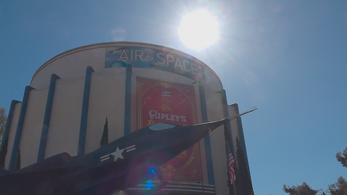 Sunlight shines over the San Diego Air and Space Museum as visitors gather ahead of the Artemis II splashdown.