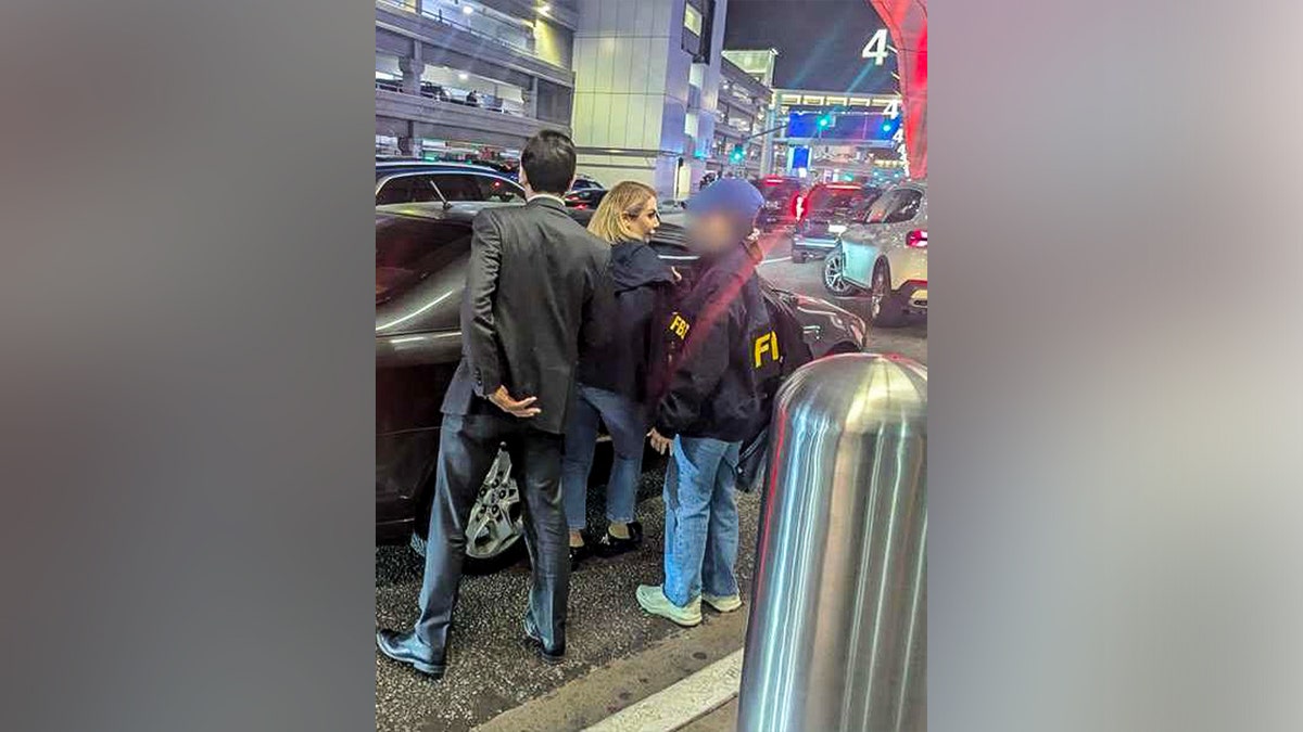 Photo of authorities arresting Shamim Mafi.