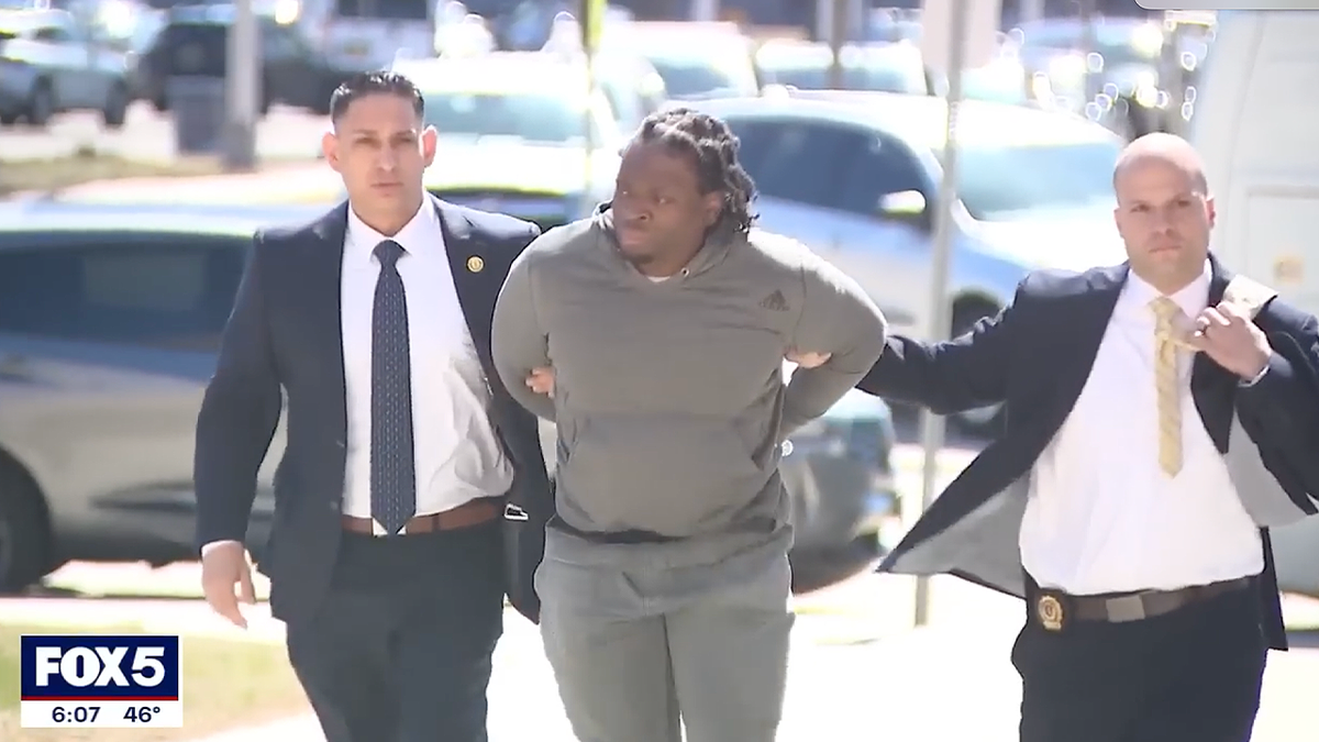 Shaquille Coke is escorted by officials