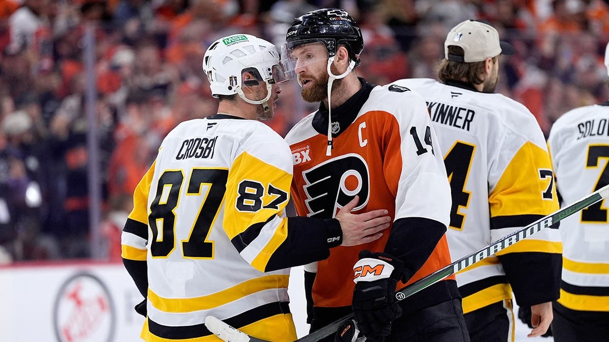 Sidney Crosby and Sean Couturier shaking hands on ice rink