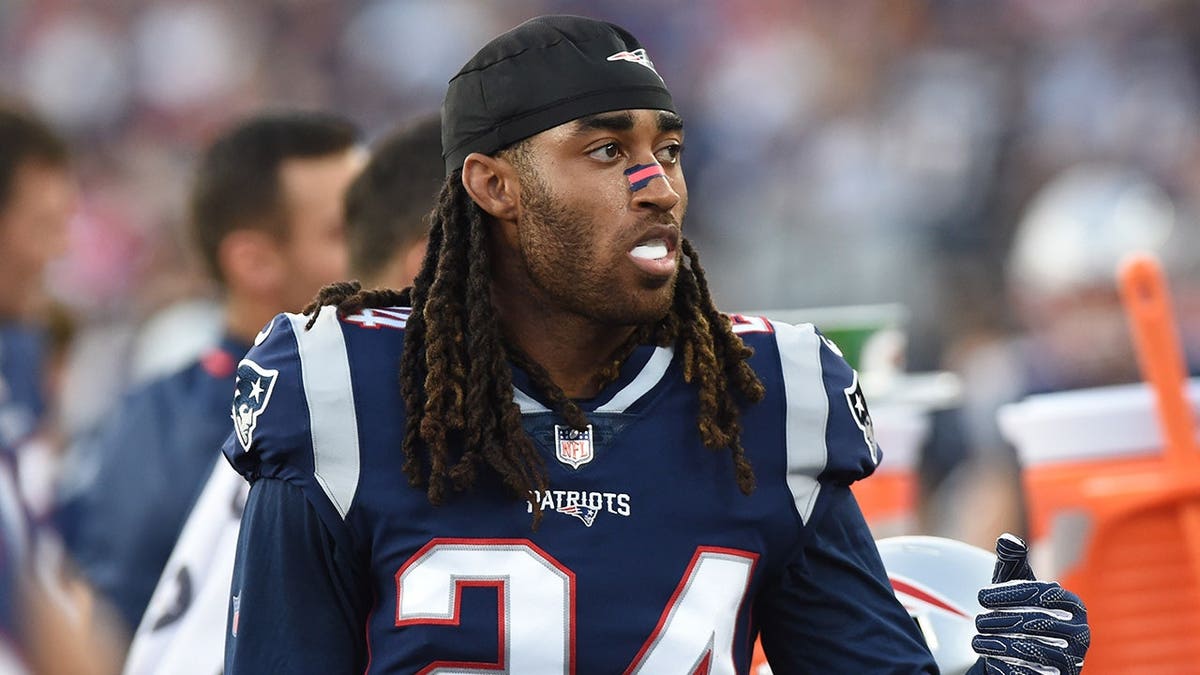 Stephon Gilmore standing on the field at Gillette Stadium