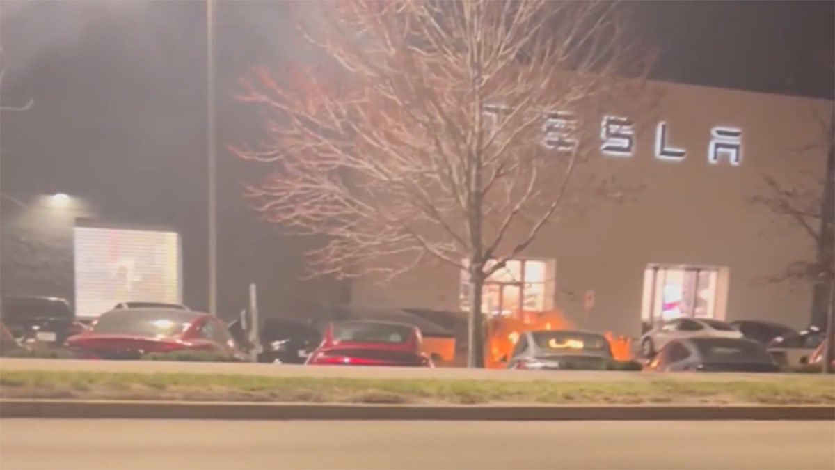 Two Tesla Cybertrucks burning at a dealership in Kansas City