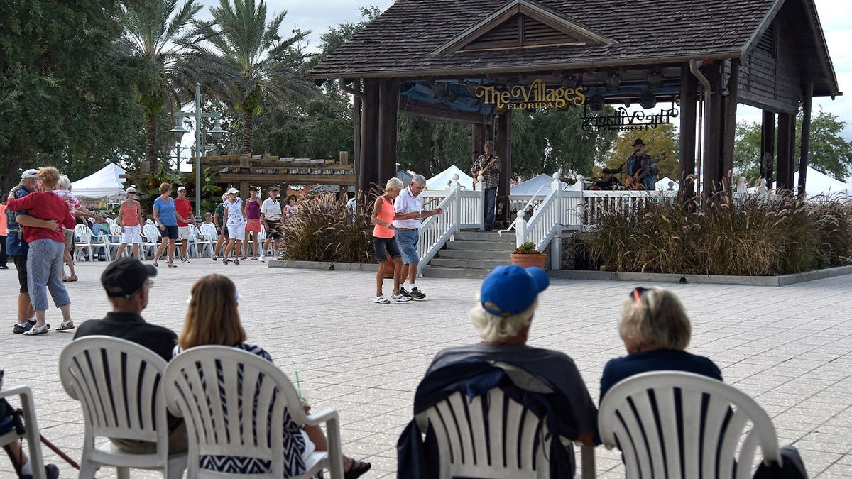 elderly residents dance at a park at a community