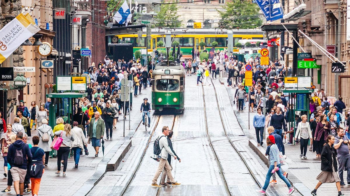 Crowded Aleksi street with people walking in Helsinki Finland