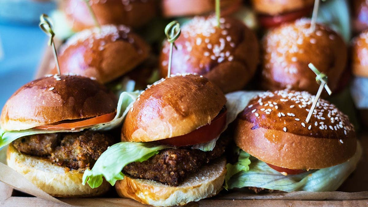A selection of hamburgers displayed on plates in a café setting