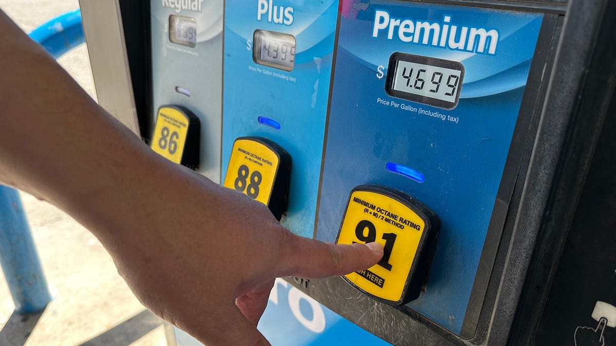 A customer pressing premium grade fuel pump at a tribally owned gas station