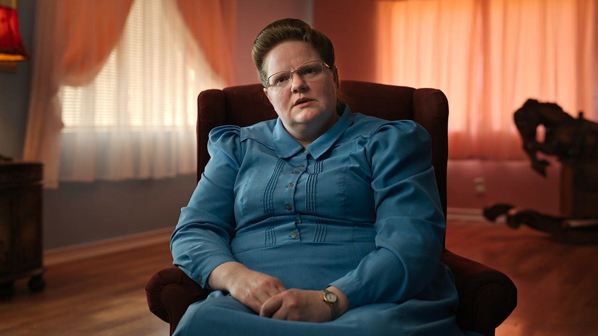 Julia Johnson standing in a scene from Trust Me: The False Prophet Season 1