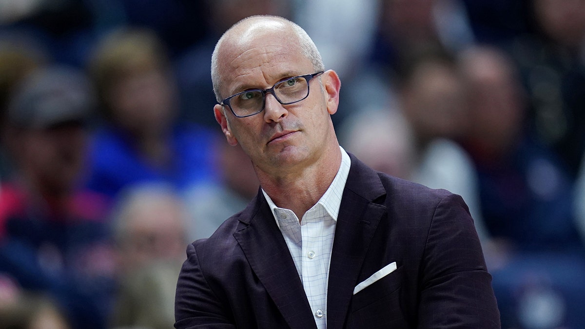 UConn Huskies head coach Dan Hurley watching from the sideline during a basketball game.