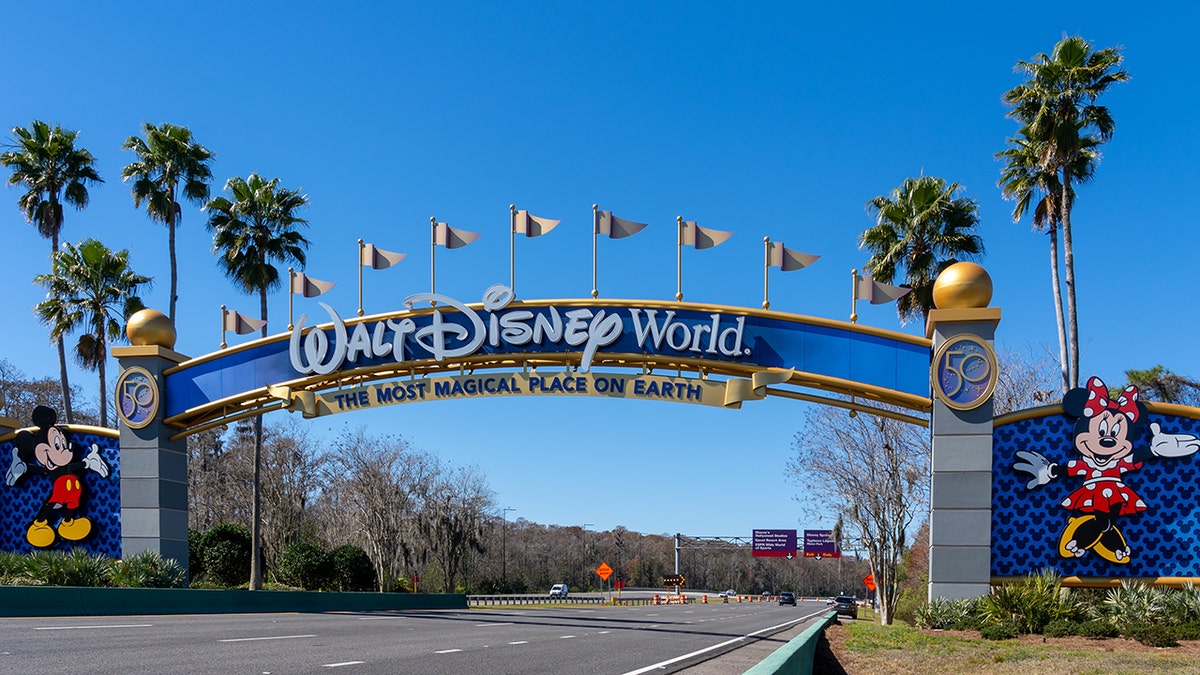 Walt Disney World entrance arch with Mickey and Minnie Mouse welcoming guests to 