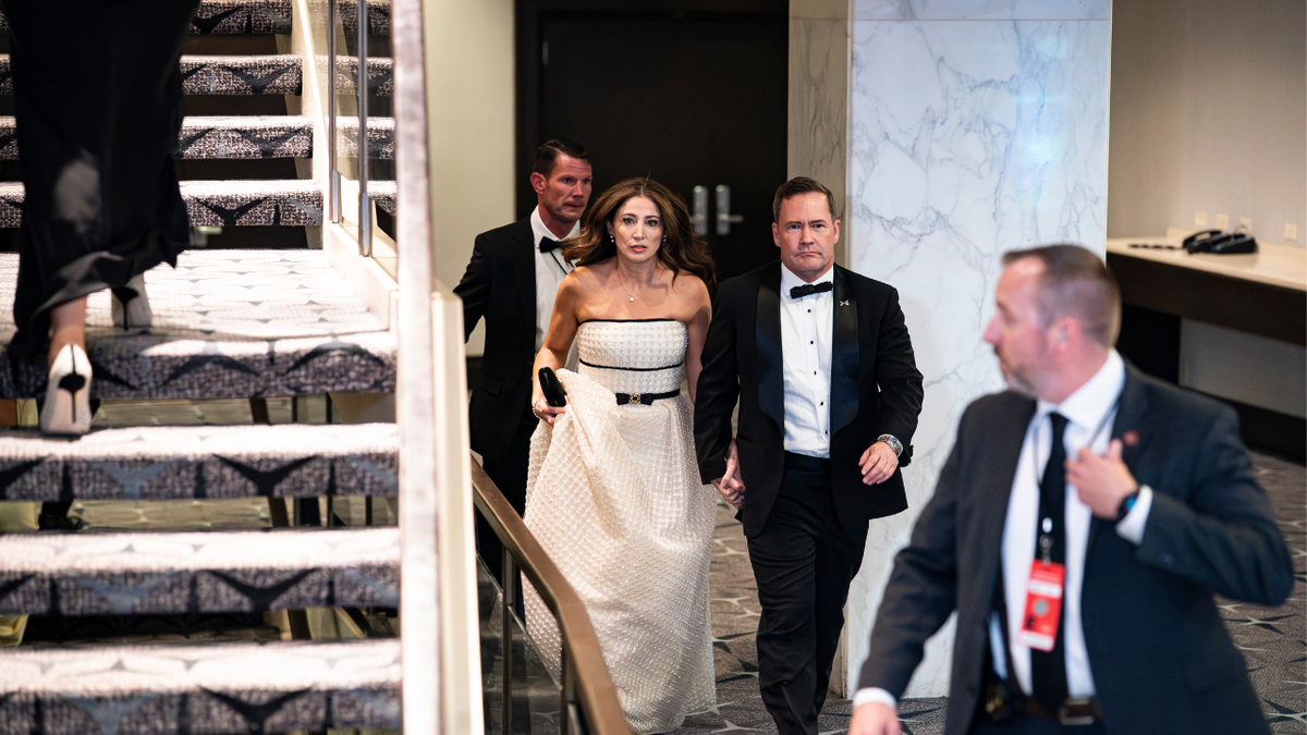 U.S. Ambassador to the United Nations Michael Waltz and his wife Julia Nesheiwat are escorted after shooting at the White House Correspondents Dinner.