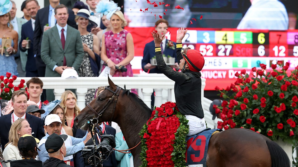 Jockey Jose Ortiz celebrating in the winner's circle at Churchill Downs.