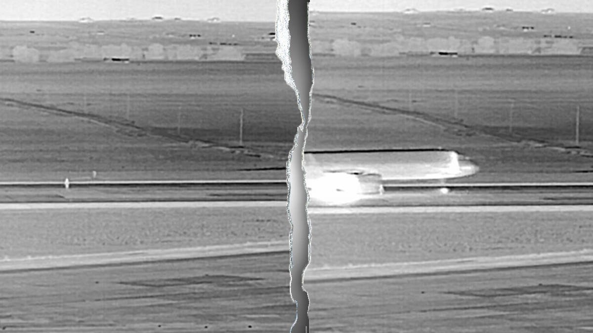 Unidentified person climbing perimeter fence at Denver International Airport in thermal imaging