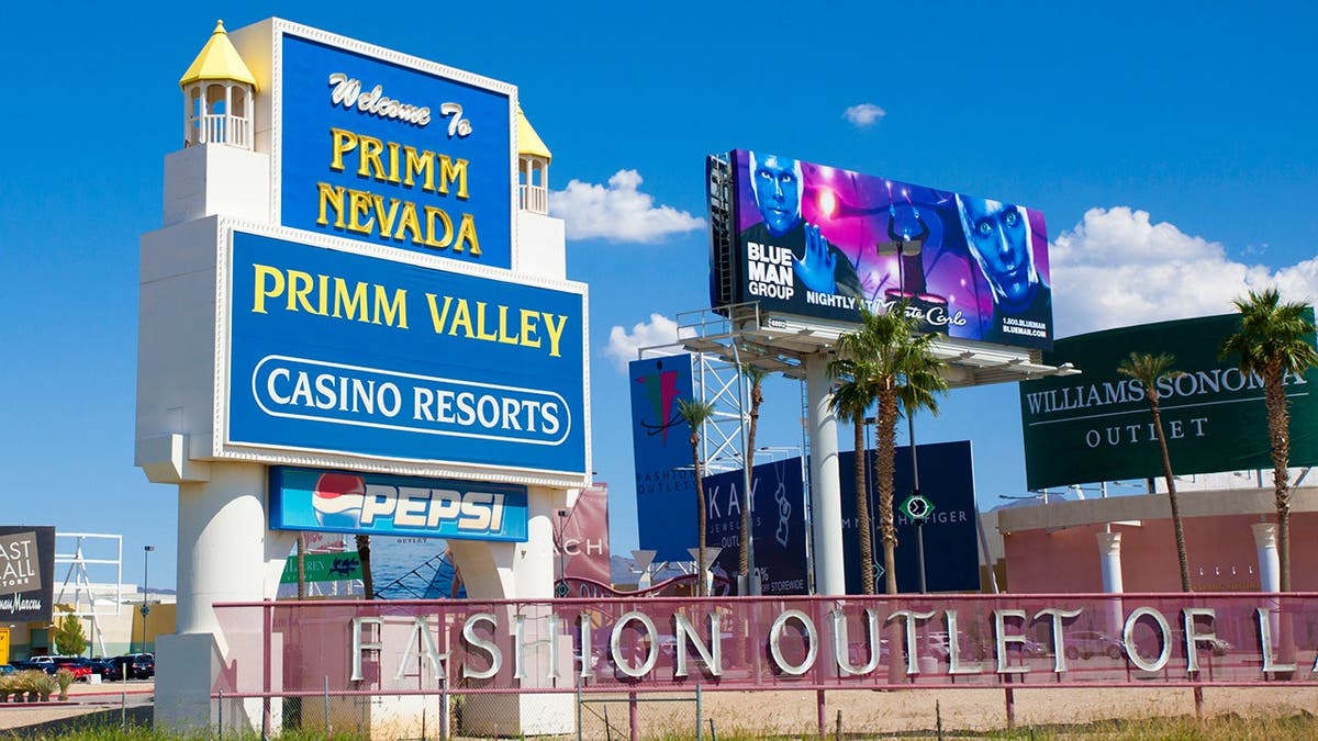 A blue sign advertising the Primm Valley Casino Resorts stands against a bright blue sky.
