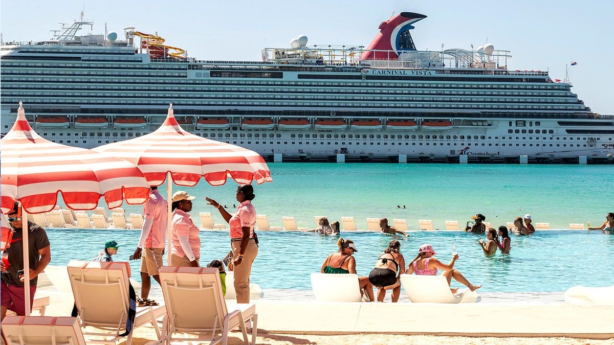 Tourists sitting on beach at Celebration Key