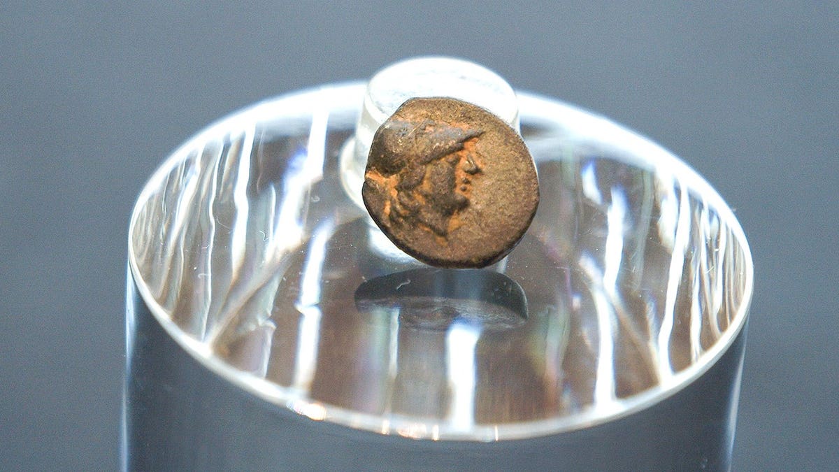 Small Greek coin on display at museum