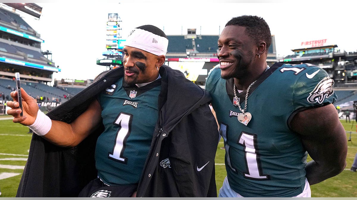 Jalen Hurts and A.J. Brown celebrating on the field at Lincoln Financial Field