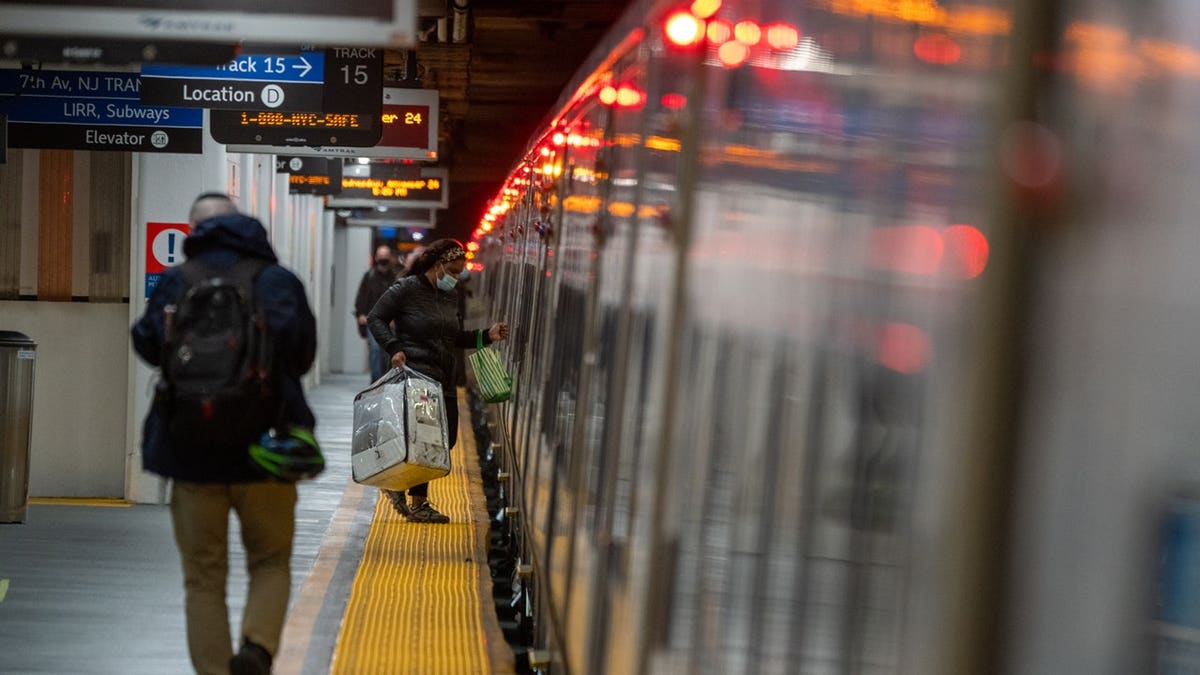 People mont the Long Island Rail Road at Penn Station on November 24, 2021 in New York City.